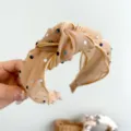Detailed view of a tan knotted mesh headband adorned with sparkling colorful rhinestones - Khaki Mesh Rhinestone Headband (S217)