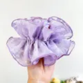 Macro view of a purple double-layered lace scrunchie showing delicate floral patterns - Waisted Floral Print / Purple