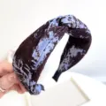 Close-up of a tie-dye knotted fabric headband with marbled blue and brown pattern - Crossover Headband (S262) / Blue Tie Dye