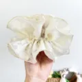 Detailed macro shot of an oversized cream lace scrunchie featuring elegant floral patterns - Waisted Floral Print / Off White