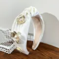 Close-up of white satin knotted headband with golden metal flowers and pearls - Knotted Flower Headband / White