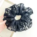 Close-up detail of a elegant black floral lace oversized scrunchie for hair styling - Large Printed Style / Black