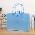 Detailed front view of a light blue felt tote bag with cute embossed bear design - Sky Blue