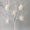 Decorative 5cm white yarn balls hanging on a stylized tree for DIY holiday decor. - 100pcs Pack / White