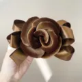 Elegant brown velvet rose hair clip featuring detailed satin ribbon bow decoration. - Brown