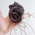 Detailed view of an elegant brown satin camellia rose scrunchie with soft ostrich feathers - Rose Ostrich Feather Hair Tie / Coffee