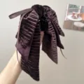 Detailed view of a vintage velvet bow hair clip with elegant ribbed texture in deep plum - Bow Ribbon Hair Claw