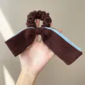 Close-up of a tweed bow hair scrunchie featuring elegant brown and blue contrast edges - Bow Scrunchie