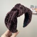 Close-up detail of a vintage dark brown velvet knotted headband with pleated texture. - Knot Headband