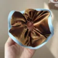 Detailed macro shot of a brown velvet scrunchie featuring a soft light blue fabric trim - Coffee Blue Contrast Velvet Scrunchie