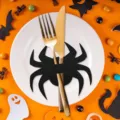 Macro view of black felt spider cutlery holder on white plate with Halloween decor - Black Spider (1 Piece)