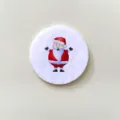 Detailed view of a circular Christmas brooch featuring a cartoon Santa Claus on felt. - Santa Claus