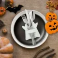 Detail of white ghost cutlery holder on a black plate with Halloween decorations - White Ghost (1 Piece)