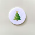 Round white brooch featuring a festive green Christmas tree design for holiday gifts - Christmas Tree