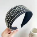 Detail view of a black padded headband featuring intricate wavy silver beaded rows. - Wide Bead Stripe Shimmer Style / Black
