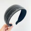 Detailed view of a wide black headband decorated with rows of shimmering silver rhinestones. - Wide Side Style / Black