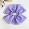 Vista macro detallada de un coletero grande de malla púrpura con elegantes perlas blancas - Estilo Plisado con Perlas / L / Púrpura