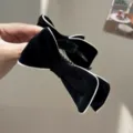 Detailed view of black velvet bow hair claw clip with elegant white piping trim - Black Bow Banana Clip