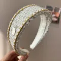 Detailed view of an elegant white tweed knit headband with gold chain and sequin accents - Chain Headband