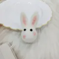 Macro view of a cute handmade white wool felt bunny head for DIY hairpins and brooches. - Long Ear Rabbit