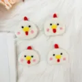 Close-up view of four handmade cute white wool felted chicken heads for DIY hair clips - Set of 4 / Little Chick