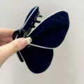 Macro view of elegant navy blue velvet butterfly hair claw clip with contrast white piping - Butterfly Style (S378) / Deep Blue (White Edge)