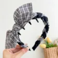 Detailed macro view of plaid bow headband featuring non-slip teeth for secure hair styling. - Rabbit Ears Toothed Style / Black And White Plaid Rabbit Ears Toothed Headband