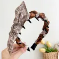 Close-up detail of a brown satin and plaid headband showing non-slip teeth and bow knot - Rabbit Ears Toothed Style / Black And Coffee Plaid Rabbit Ears Toothed Headband