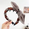 Detailed view of vintage houndstooth headband with rabbit ear knot and inner teeth - Rabbit Ears + Tooth Comb Headband / Coffee Plaid
