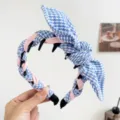Close-up of blue and white houndstooth headband with pink twist and rabbit ear bow - Rabbit Ears + Tooth Comb Headband / Blue Pink Plaid
