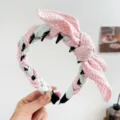 Detail of retro houndstooth bunny ear headband with braided twist and inner comb teeth. - Rabbit Ears + Tooth Comb Headband / Pink and Green Plaid
