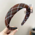 Detailed view of a vintage brown plaid wide-brimmed headband with fabric texture. - Sponge Headband (S397) / Coffee Plaid