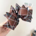 Close-up of a retro brown plaid bow hair clip with intricate fabric texture and pleats. - Bow Banana Clip (S397) / Coffee Plaid