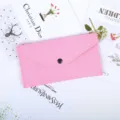 Close-up detail of the pink felt envelope pouch with a black snap button closure - Pink