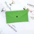 Detailed view of the bright green felt envelope storage pouch with a snap button closure - Green