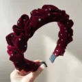 Macro detail of elegant burgundy velvet ruffled headband with colorful sparkly dots - Flocked Headband / Colorful Retro Red