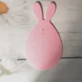 Pink felt bunny-shaped Easter cutlery holder decoration on rustic white wood background - Pink Round Rabbit