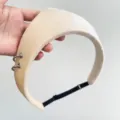 Macro detail of a cream velvet padded headband featuring decorative silver metal rings - Crown Ring Hairband / Adjustable Size / Beige