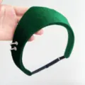 Close-up of a green velvet headband with silver ring accents and adjustable strap. - Crown Ring Hairband / Adjustable Size / Dark Green