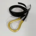 Detailed view of women's black leather belt featuring a large gold U-shaped buckle. - Black