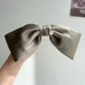 Elegant grey satin bow hair clip with gold heart charm detail macro view showcase - Bow Spring Clip / Green