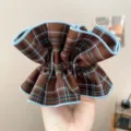 Detailed close-up of retro plaid fabric scrunchie featuring blue stitched edges for hair - Pleated Scrunchie (S397) / Coffee Plaid (Blue Edge)