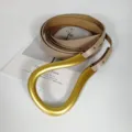 Beige leather belt with a distinctive large gold horseshoe buckle, stylish women's waist accessory. - Light Khaki