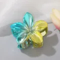 Detailed view of the metallic gradient blue and yellow frangipani flower hair claw clip - Green + Lake Blue (3756)
