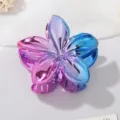 Detail of metallic gradient frangipani flower hair claw clip with vibrant glossy finish - Rose Red + Blue (3758)