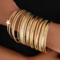 Detailed close-up of 18-piece gold bangle set with star charm and twisted textures - 18-Piece Set - Star (6553201HB) / Gold