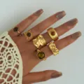 Close-up of vintage gold ring set featuring tiger eye stones and irregular textures - Vintage Irregular Texture Style (6512801HB) / 12 Pieces/Pack / Gold