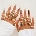 Close-up of a vintage gold geometric ring set featuring irregular lava and tiger eye stones. - Vintage Irregular Lava Geometric Plain Ring Set (6703401HB)
