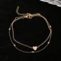 Close-up of a double-layer gold anklet featuring a heart charm and elegant bead accents - Double Layer Polished Heart Style (5099101HB) / Gold