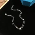 Macro view of double-layer silver tone anklet featuring a polished heart charm and beads - Double Layer Polished Heart Style (5099102HB) / Silver